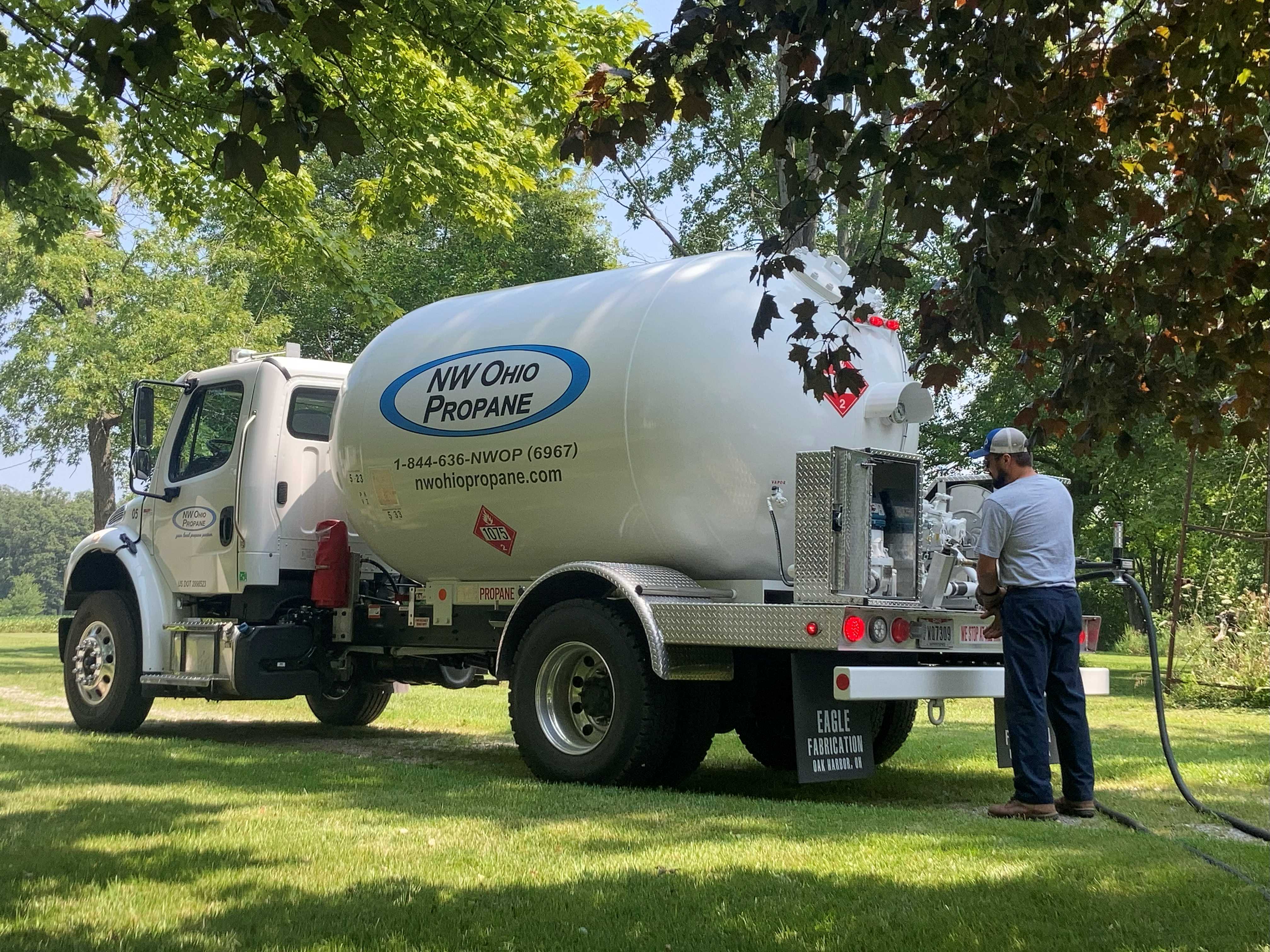 man standing behind propane truck